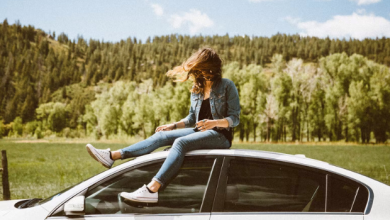 Girl Sitting on the Roof of the Car